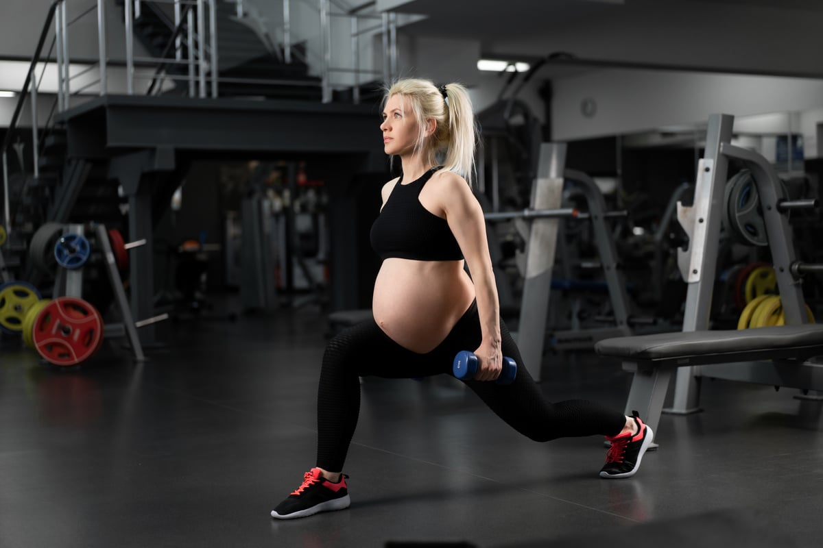 Pregnant Woman Doing Lunge Exercises in the Gym